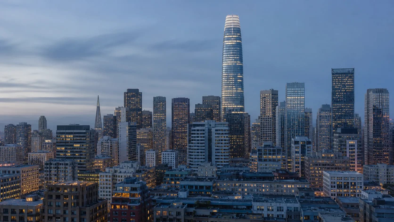 Blue-hour view of downtown San Francisco with Salesforce Tower and the Financial District skyline.